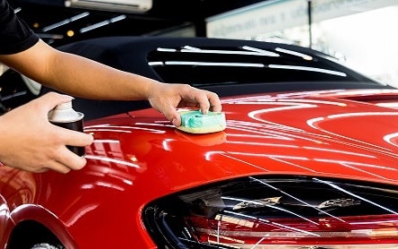 Car Service Worker Applying Nano Coating On A Car Detail